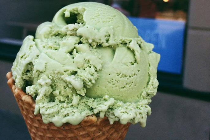 super close up of green ice cream in waffle cone