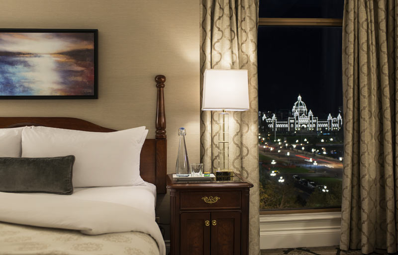 Closeup view of poster bed with view of parliament buildings in lights at night.