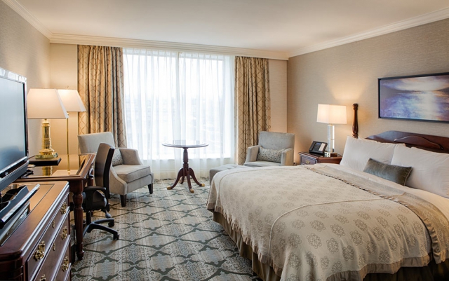 Superior king room with large window, computer desk and flatscreen tv.